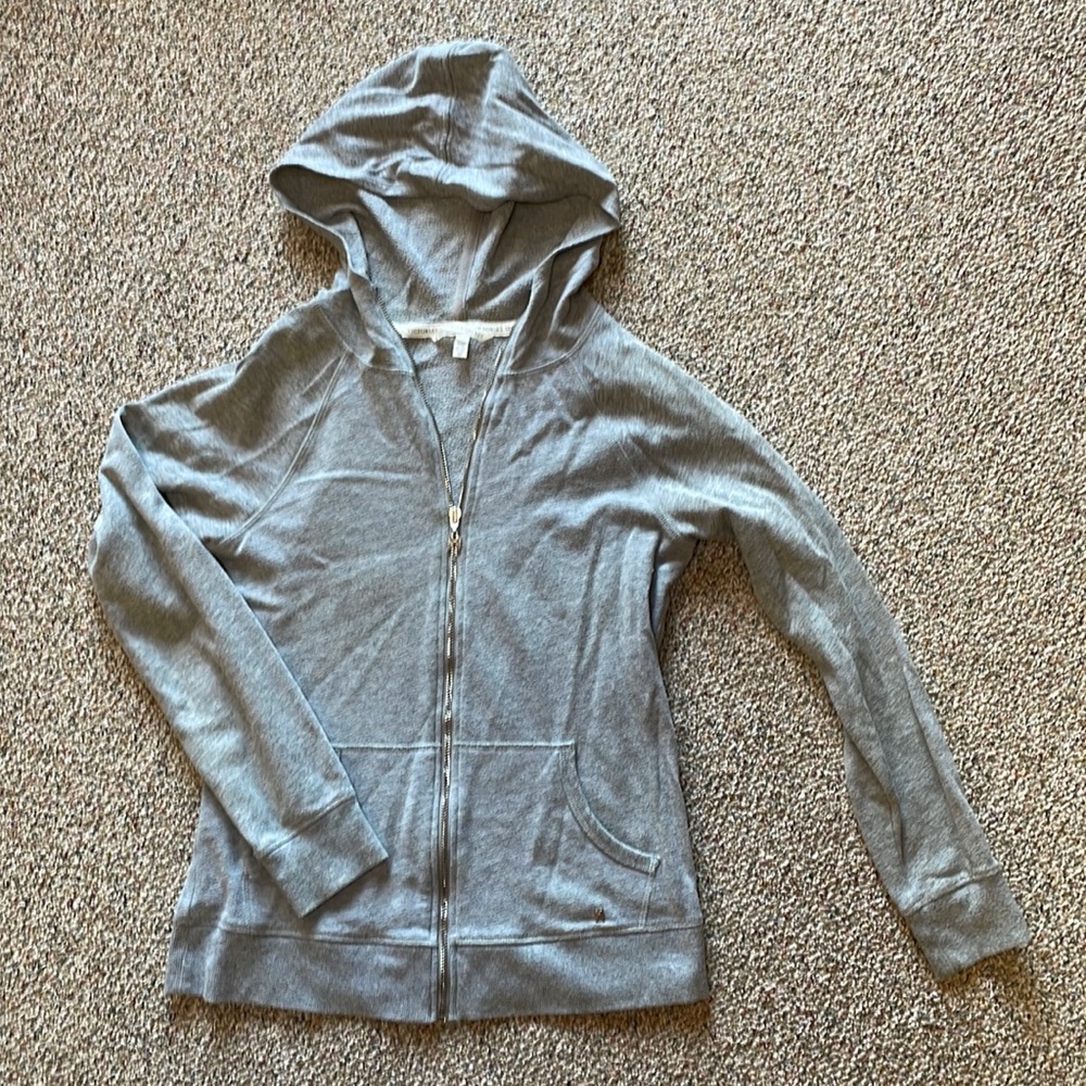 Victoria’s Secret hooded zip up sweatshirt with black heart decal on back.
